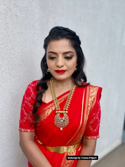 A classic combination of a red saree with bold red lips. This look is timeless and powerful, featuring a matte red lip and a subtle smoky eye for a touch of drama.
