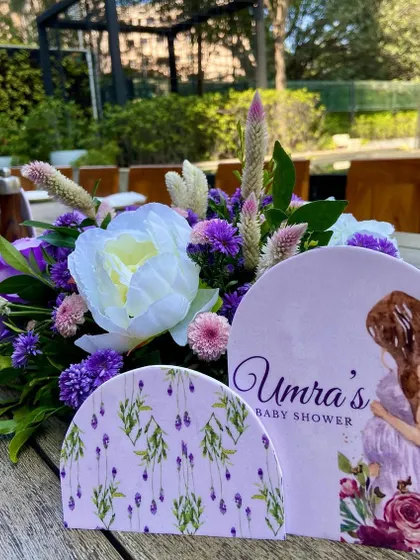 The custom-designed stationery for Umra's lavender-themed baby shower, perfectly matching the floral centerpieces on the tables.