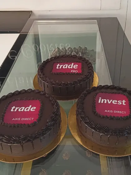 For large corporate events, I can create multiple cakes with consistent branding. This order for Axis Direct features their different service logos on rich chocolate cakes, perfect for a multi-team celebration or brand activation.