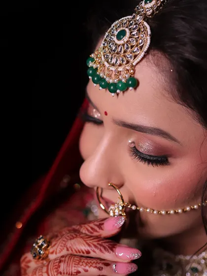 Urvashi's subtle and natural bridal look. We focused on soft, shimmery eyes and flawless skin to complement her gorgeous red lehenga and emerald jewellery.