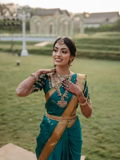 A radiant bride in her teal Kanjeevaram saree. We love capturing the vibrant colors and rich traditions of South Indian weddings.