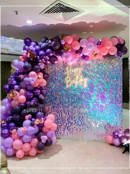 I love adding a bit of sparkle to my events. This iridescent shimmer wall, paired with a custom neon "Happy Birthday" sign and a vibrant balloon arch, created the perfect glamorous photo corner for guests at Shanvi's birthday party.