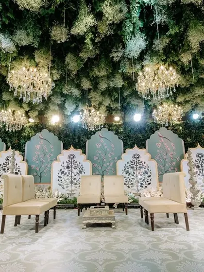 With lush greenery, cascading florals, and twinkling lights, my enchanted forest decor transforms this wedding into a magical wonderland. This stage design is where fairytales meet reality.