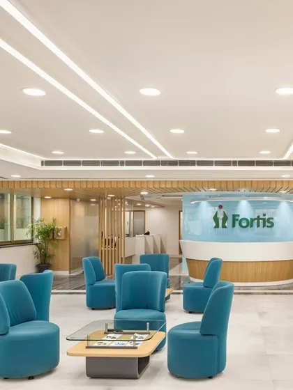 The reception desk at Fortis Ludhiana is a focal point, designed with soft curves and a clean, modern aesthetic. The space balances hospitality-driven comfort with healthcare functionality, fostering an environment that facilitates healing.