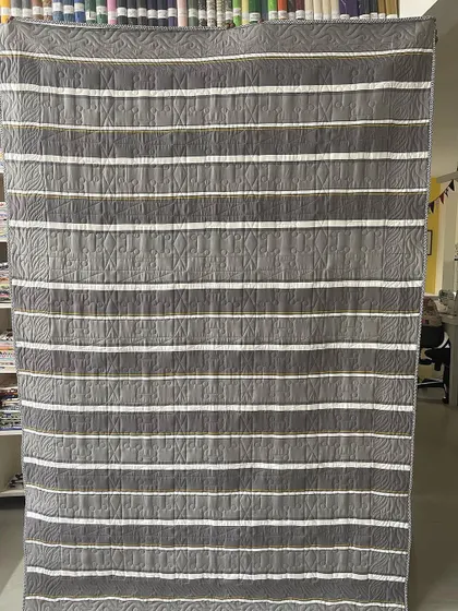 The striped backing fabric of the Pinwheel quilt.