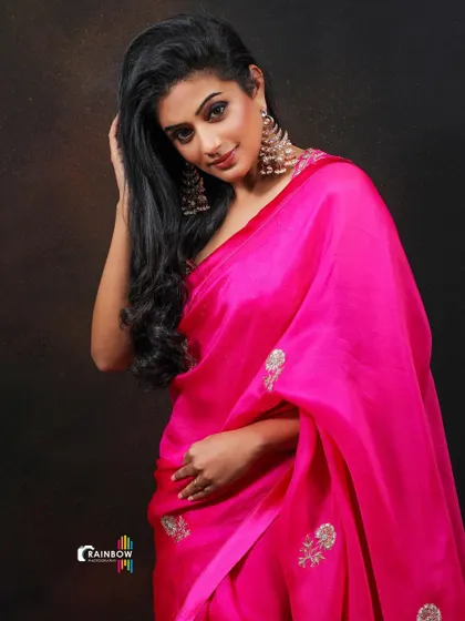 A beautiful portrait of Priyamani, where the soft lighting enhances the elegance of the pink saree and her graceful pose.