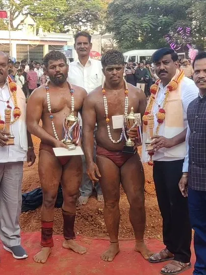 Celebrating the winners of a Kusti competition. These athletes have shown incredible strength and skill in the wrestling pit.