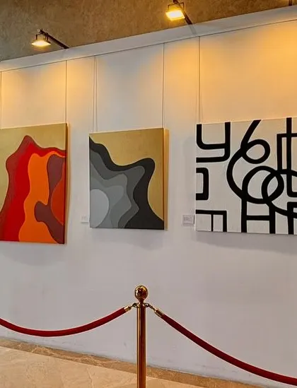 A selection of abstract paintings from the 'Inner Tides' exhibition, showcasing a variety of styles from minimalist black and white to layered, colorful compositions.