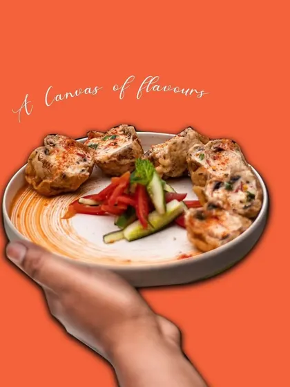 A plate of our creamy Malai Tikka, presented as a canvas of flavors. The tender chicken is marinated in a rich, non-spicy mixture, making it a favorite for all age groups.