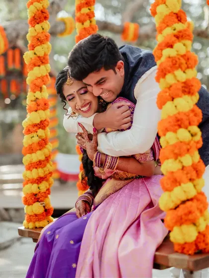 A sweet embrace amidst the marigold decor. We captured this candid moment between the couple on a swing, showcasing their playful connection during their wedding celebrations at The Tamarind Tree.