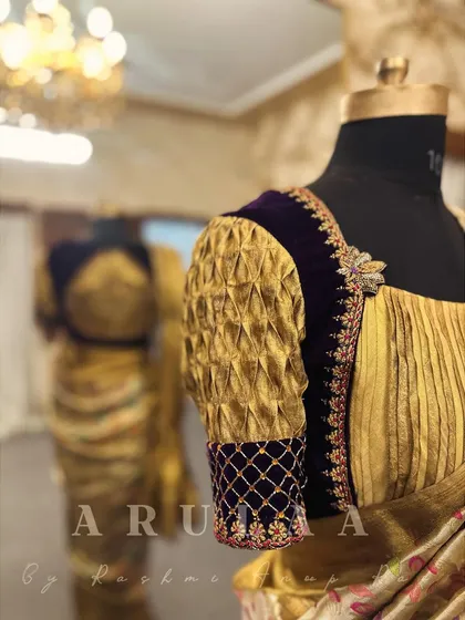 The sleeve of the purple velvet and gold tissue blouse, showing a combination of smocking and jaal embroidery. I love mixing textures and techniques to create unique designs.