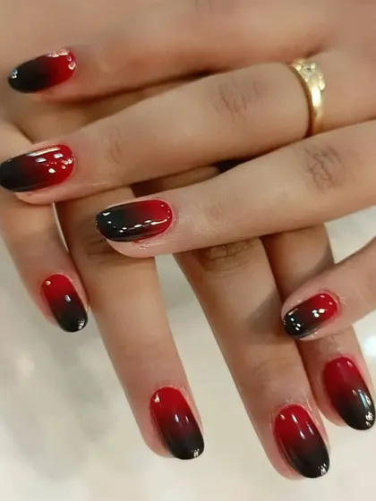 Another example of our popular red and black ombre, this time on shorter, rounded nails for a more subtle effect.