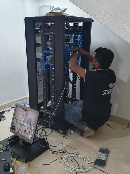 Installation is more than just cameras. Here I am organizing the network cables inside a server rack for a large IP camera system.