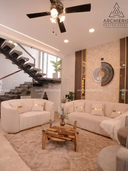 Another angle of the duplex villa's living room, showing the comfortable, curved sofas and the beautiful natural light. The design is perfect for a modern, luxurious lifestyle.