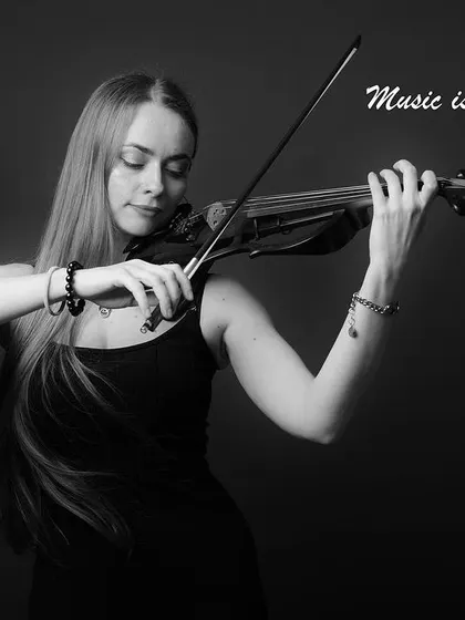 A black and white version of the violinist's portrait, with text that reads "Music is the Answer...". This adds an artistic and emotional layer to the image.