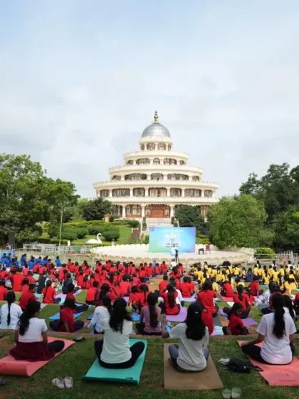 Students in colorful uniforms participate in a large-scale yoga event. We bring yoga and meditation to thousands of school children to provide them with tools for mental and emotional well-being early in life.
