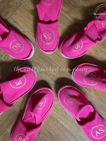 Let your bridesmaids walk beside you in comfort and style. These vibrant pink slippers are personalized with each of their initials, making for a cute and practical gift.