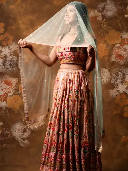 A playful shot showing the delicate net dupatta with sequin work. This lehenga is all about the beautiful details and happy vibes.