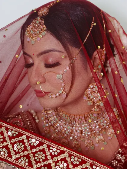 The soft lighting in this photo highlights the gentle glow and shimmer of the eye makeup.