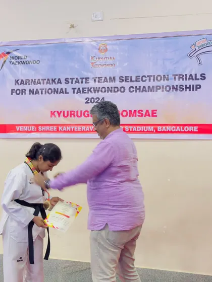 The moment of victory. A black belt student from our academy being awarded her medal at the state selection trials.