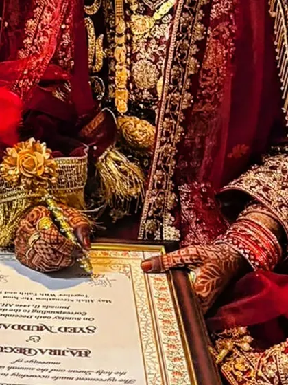 A bride's hands during the nikah ceremony, with the rich henna stain looking absolutely perfect.