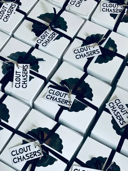 A sea of modern, monochrome gift boxes for the brand 'Clout Chasers'. This showcases our capability to handle high-volume orders while maintaining a sharp and consistent brand aesthetic.