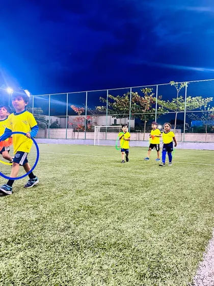 Kids having fun with hoops during a night session. Our training continues under the lights, providing a great after-school activity.