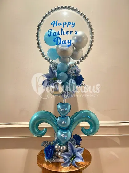 A sophisticated balloon bouquet designed for Father's Day. The cool blue and silver tones, combined with a personalized message, create a stylish and heartfelt tribute to dad.
