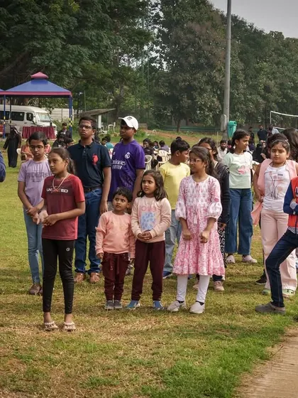An instructor addressing a group of children during a team engagement day. We organize activities that are both fun and educational for kids of all ages.