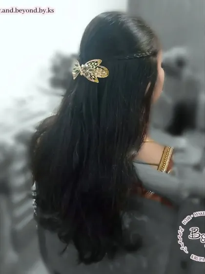 For clients with straight hair who want a simple yet elegant look, a half-up style is perfect. I created a small crown braid and added a beautiful gold butterfly accessory to finish this classic hairdo.