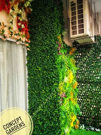 This image shows how we expertly work around existing structures like air conditioning units, integrating them seamlessly into the green wall design.