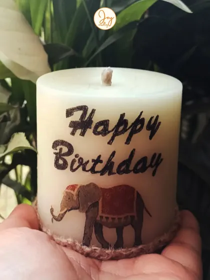 A custom "Happy Birthday" pillar candle with an elephant design. I love creating these personalized candles for clients to stock up on for their friends' birthdays.