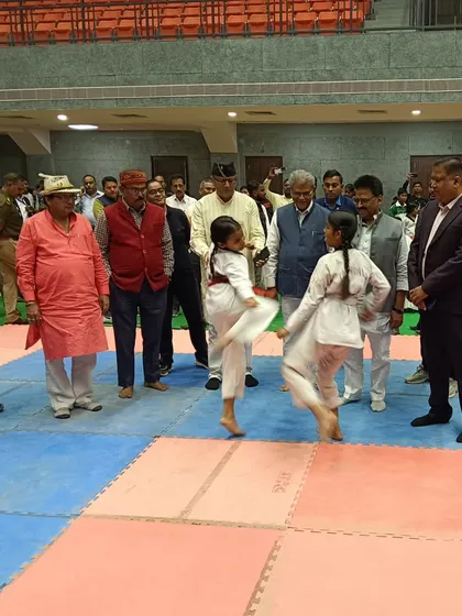 Officials watch a demonstration by two young female Taekwondo athletes. These events not only provide competition but also serve as a platform to showcase the sport to the wider community.
