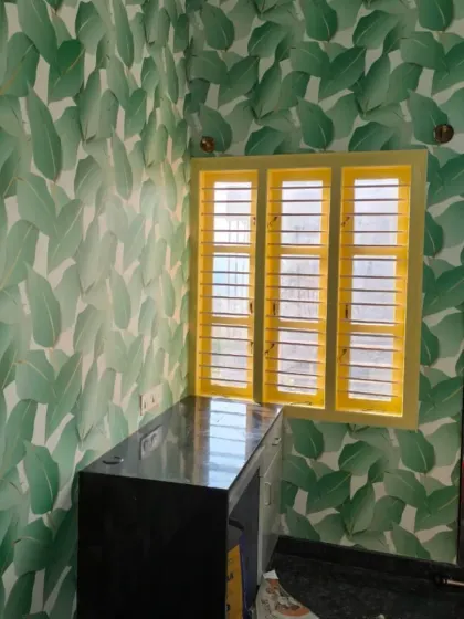 A bright green leaf wallpaper that creates a fresh and vibrant feel. The yellow window frame provides a nice contrast.