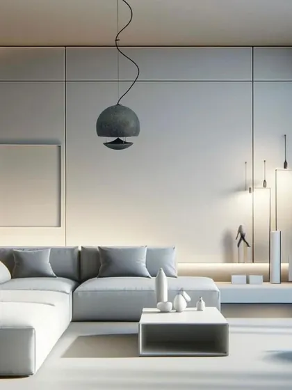 Here, the same Spherina speaker is shown in a minimalist, monochromatic living room. Its sculptural form stands out as a design element, proving that you don't have to compromise on style to get incredible audio performance in your home.