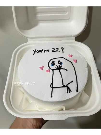 A cute and shy meme character on a bento cake for a 22nd birthday.