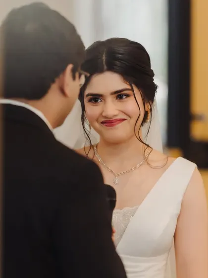 The way she looks at him. Her makeup is soft and romantic, with a rosy lip that perfectly captures the love in her eyes.