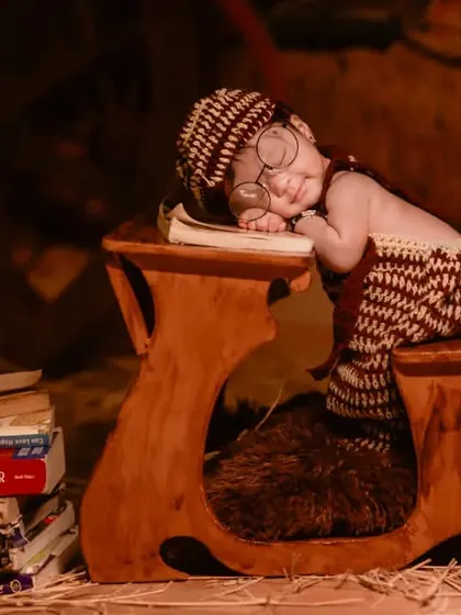 A black and white version of the tiny scholar asleep on his desk, emphasizing the classic and timeless feel of the portrait.
