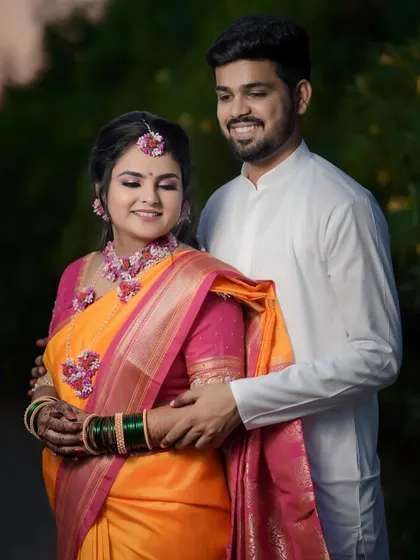 A happy portrait of the couple embracing. Their smiles show the joy and excitement of their wedding celebrations, dressed in traditional Haldi attire.