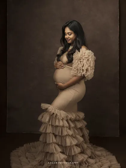 A gentle, downward glance, a hand on her belly. This pose is full of love and quiet contemplation, a mother connecting with her unborn child.