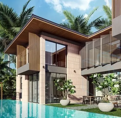 The rear view of a Goa villa, showing the private pool and patio area. The design features a mix of materials, including stone, wood, and glass, to create a modern tropical home that is both luxurious and connected to its environment.