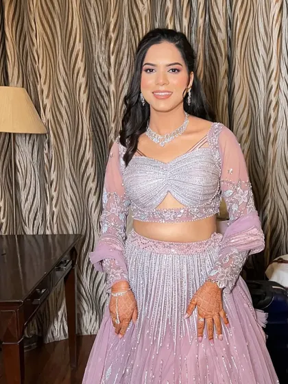 The complete look, showing how the soft makeup and simple hairstyle perfectly complement the intricate details of her engagement outfit.