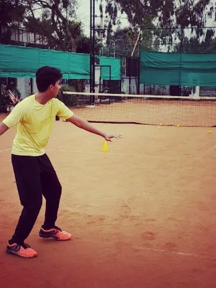A student refines his backhand technique during a drill. I provide specific feedback to correct and improve the mechanics of every stroke.