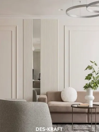 This living room design features clean lines and a neutral color palette. The textured wall behind the sofa and the modern ring light fixture add layers of visual interest.