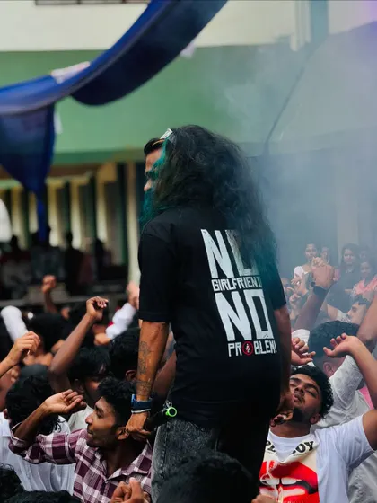 A view from behind me, showing my perspective of the hyped-up student crowd during a daytime college fest.