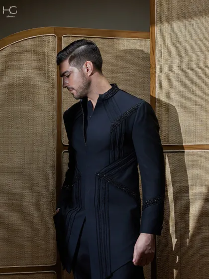 A profile view of the embroidered achkan, emphasizing its sharp, clean lines and the way the intricate details draw the eye.