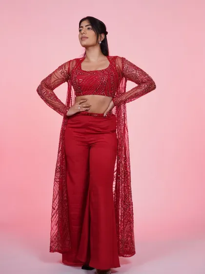 Another powerful pose in the red three-piece set. This outfit is all about confidence and owning your style.