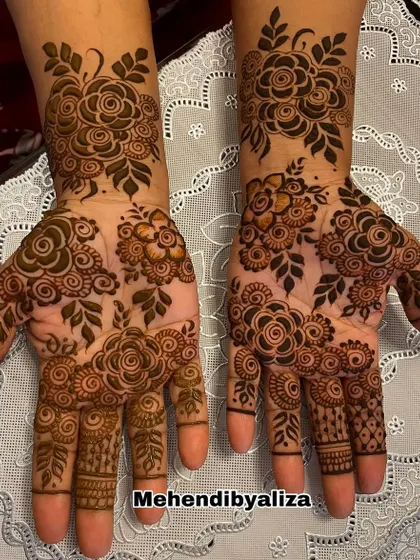 A stunning Dubai-style henna design with bold floral patterns and intricate details.