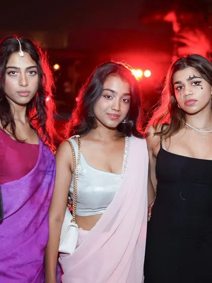 Guests blending traditional wear with spooky makeup for a unique Halloween look.