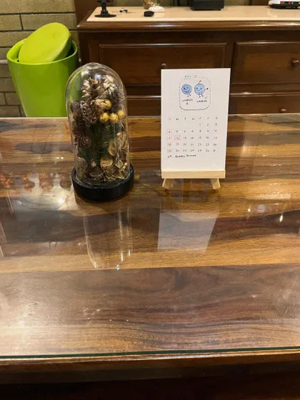 See how the calendar looks on a wooden center table, blending in as a piece of simple, cute decor.